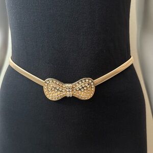 Gold tone metallic bow buckle skinny belt